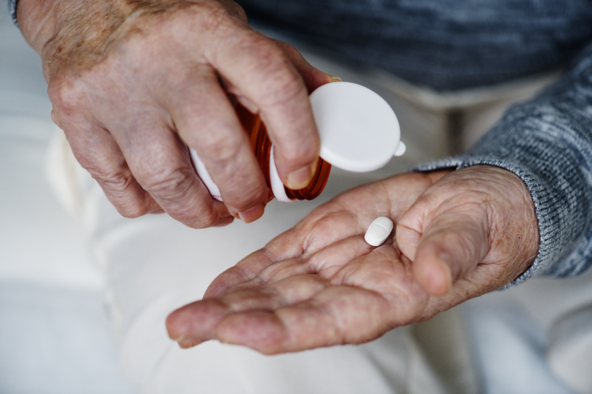 Elderly woman taking a medicine